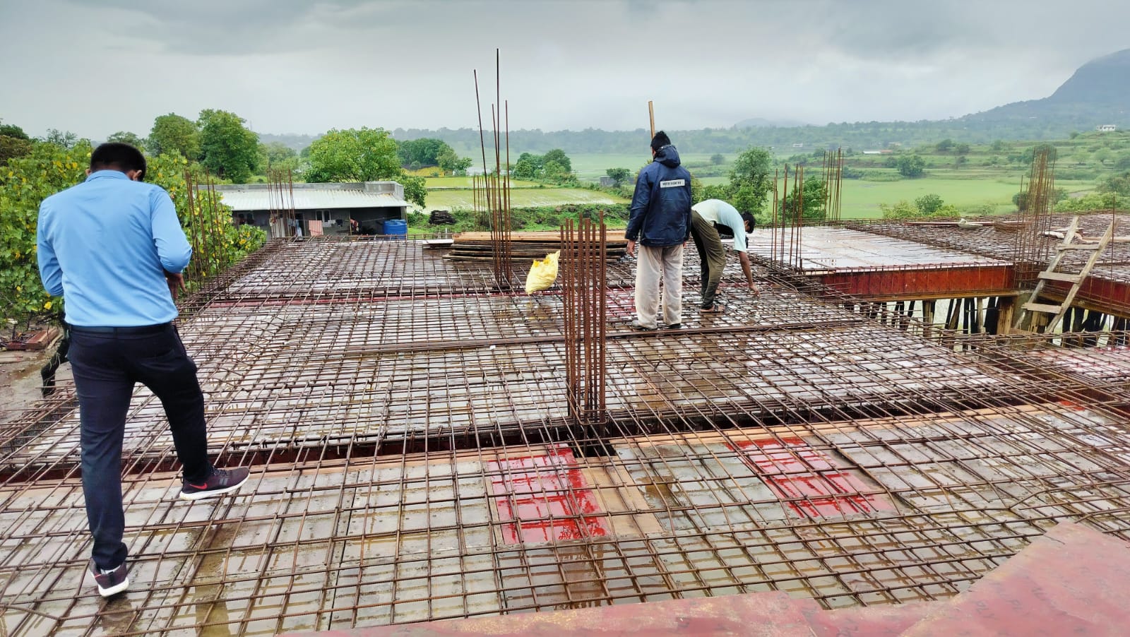Team members on a slab reinforcement deck at a G.M. Infra construction site